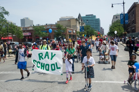 Ray School representatives march west down East 53rd Street during the 26th annual 4th on 53rd Parade, Tuesday, July 4, 2017.